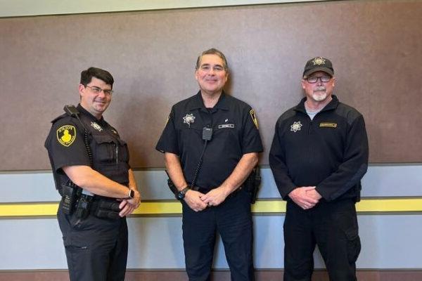 Three male officers of the black hawk police department pose for a picture together.